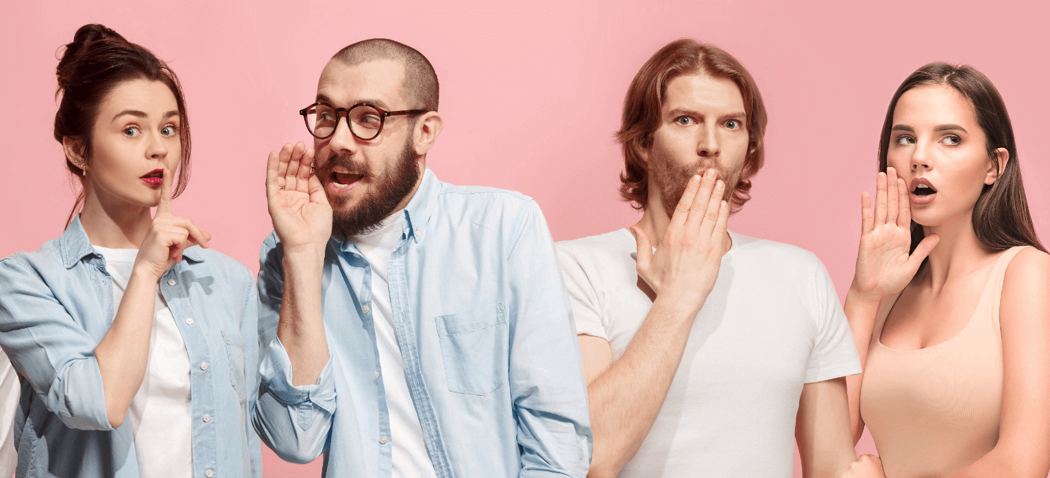 Group of friends whispering to each other pink background