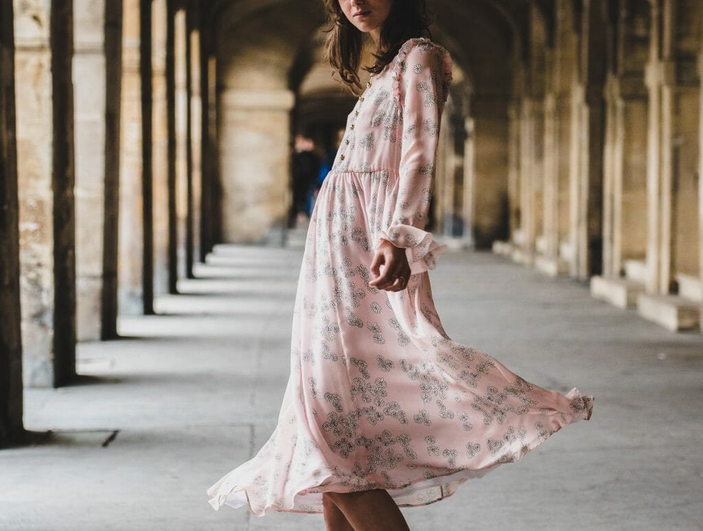 Woman in pink dress dancing after finding loans online instant approval