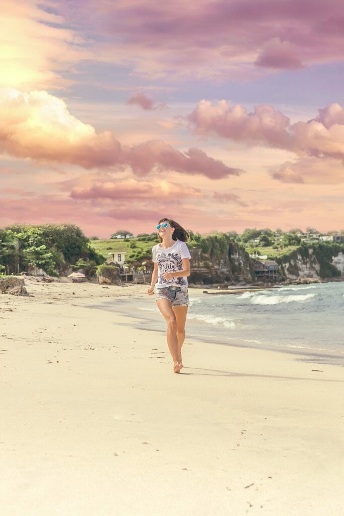 Woman running on beach towards quick cash loans