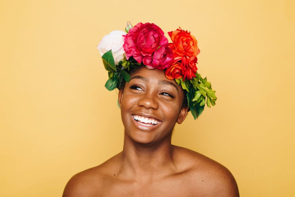 Smiling woman in flower crown thinking about quick loans