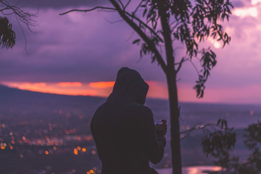 Man at dusk looking for online loans instant approval Australia on iPhone