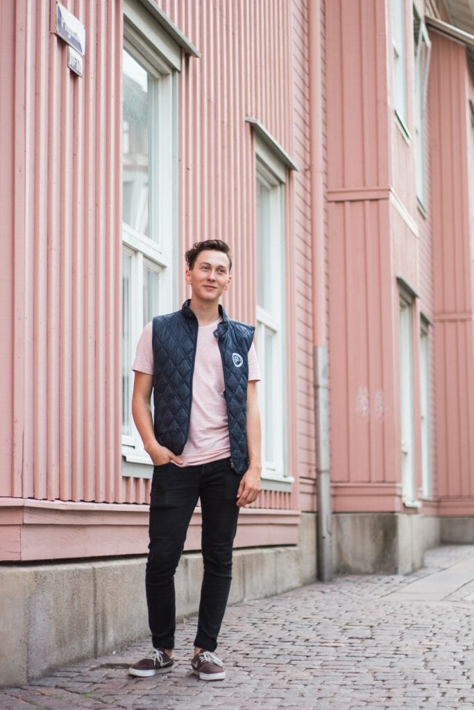 Man wearing jacket walking down street looking for money lenders