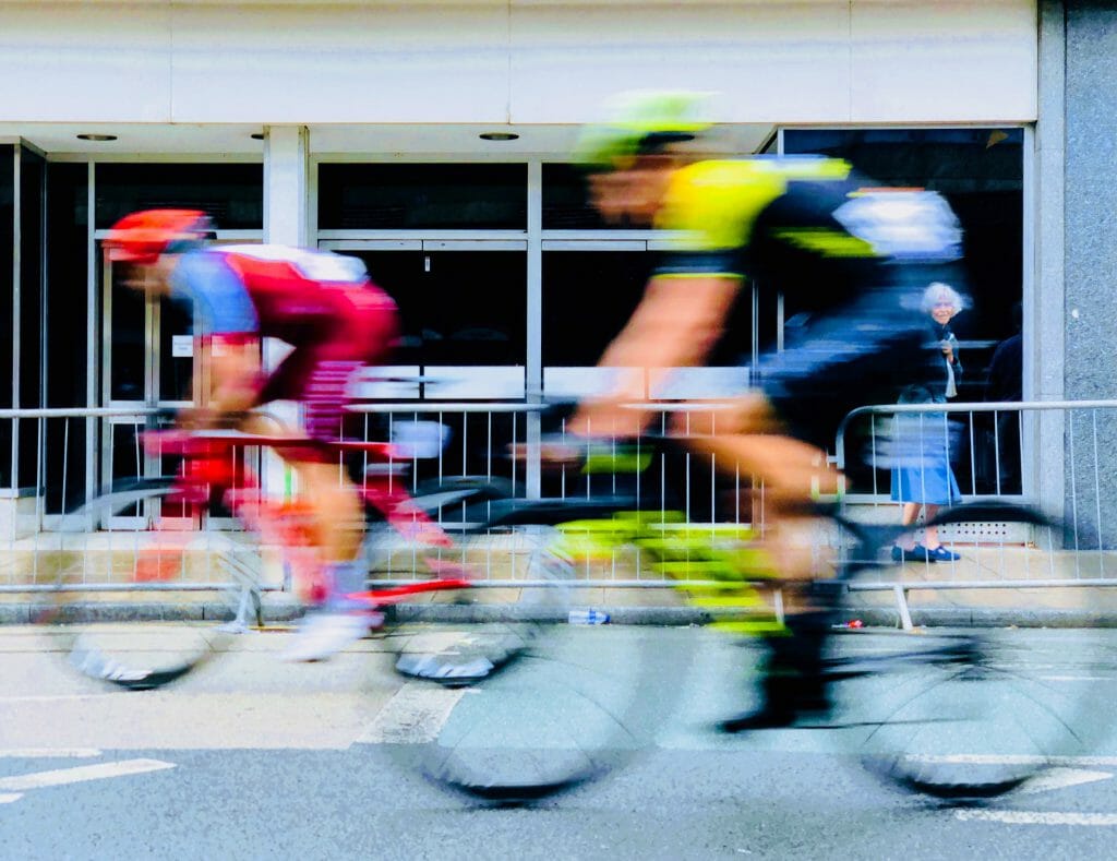 Two cyclists riding towards quick money loans