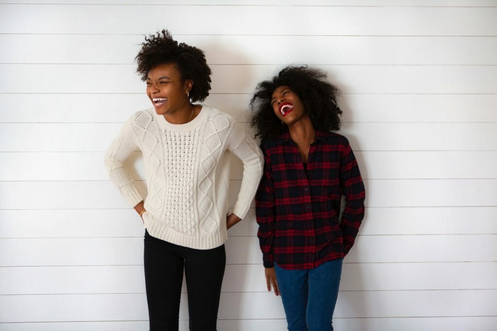 Two women laughing together about a secured personal loan