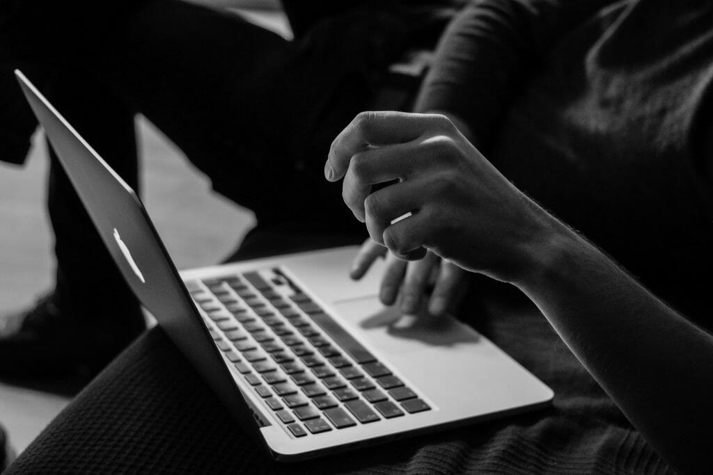 Black and white image of person browsing for small loans fast online