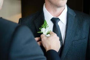 Groomsmen gifts Australia man putting flower on lapel