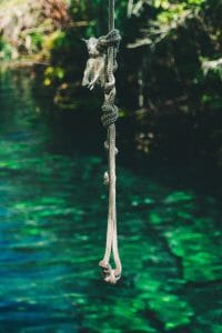 Swimming holes rope in front of tropical pool